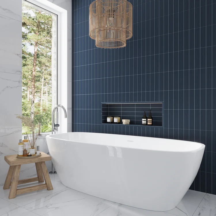  Bathroom interior featuring a freestanding tub against a dark matte blue vertical subway tiled wall